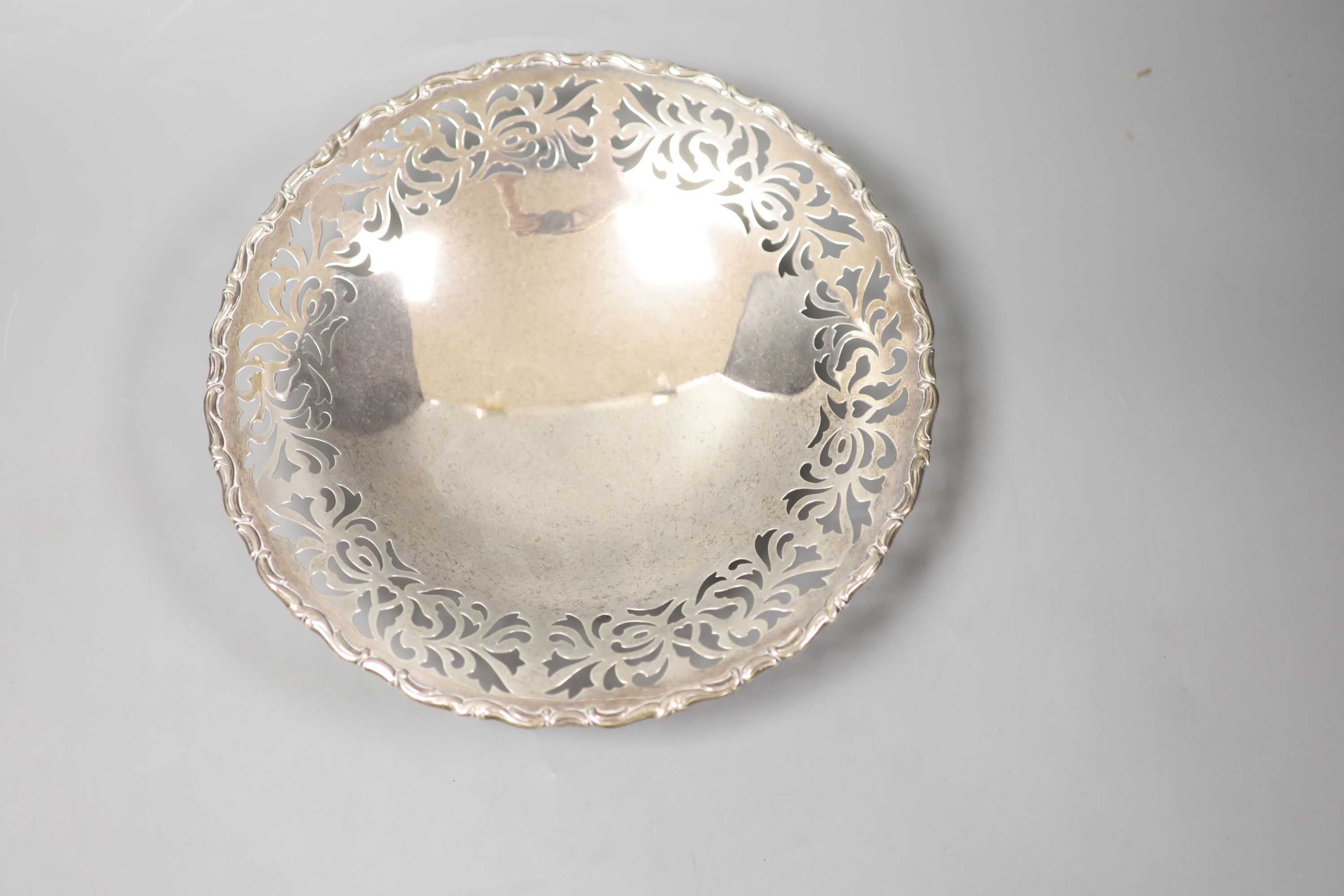 A Chinese circular white metal cake dish with pierced border